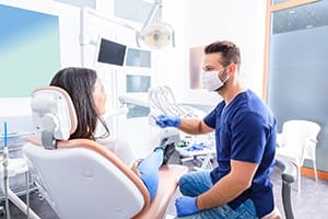 Dentist and patient talking during preliminary treatment appointment