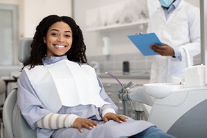 Woman smiling while sitting in treatment chair