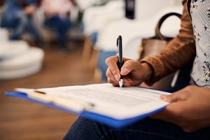 a patient filling out an insurance form