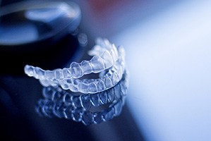 Clear aligners on dark, reflective surface