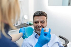 Dentist about to hand SureSmile to patient