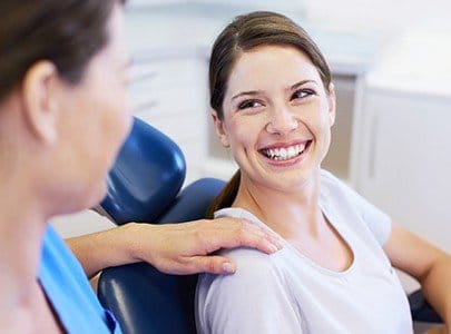 Woman smiling at dentist during dental checkup
