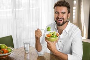 Man eating vegetables in Cary