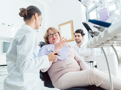 mature patient talking to dentist about dentures in Cary  