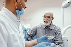 Man learning about dentures in Cary