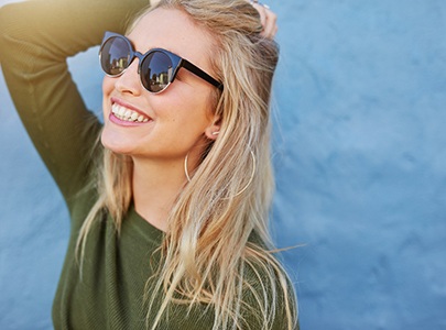 Woman with sunglasses smile after treating her toothache in Cary