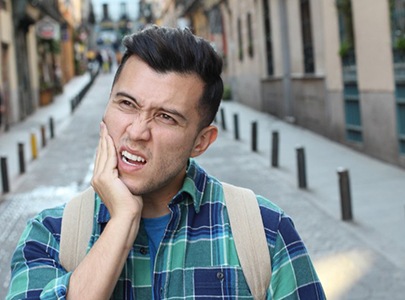 Pained man with questions about dental emergencies in Cary