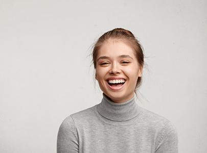 woman smiling after getting tooth-colored fillings in Cary