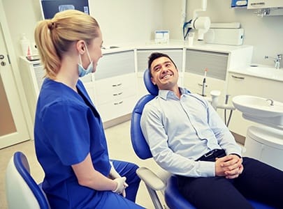 dental patient smiling at his hygienist 