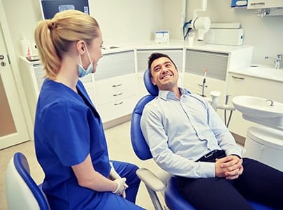 dental patient smiling at his hygienist
