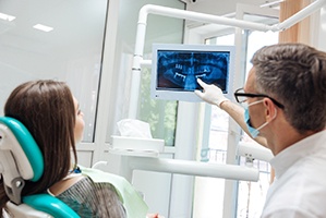 dental implant dentist in Cary showing a patient their X-rays 