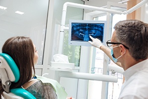 dental implant dentist in Cary showing a patient their X-rays