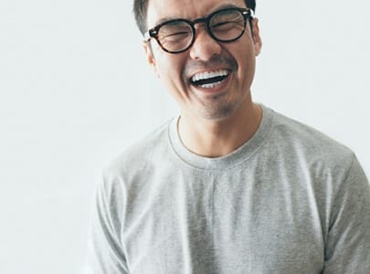 person laughing with Invisalign aligners