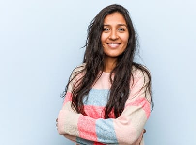 person smiling and crossing their arms