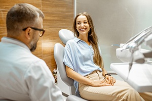 Female patient smiling at dentist at routine check-in