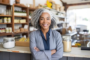 Woman with crossed arms smiling in store