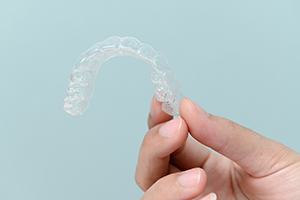 Patient holding clear aligner