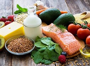 Table spread with food that can help prevent dental emergencies in Cary