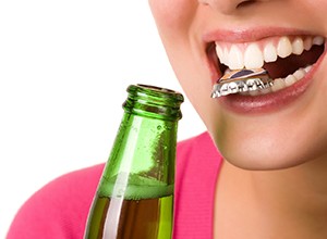 Woman headed for dental emergency in Cary with bottle cap between teeth