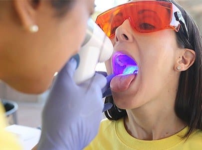 Woman receiving oral cancer screening