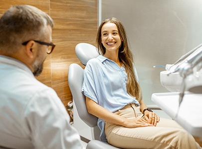 dentist and patient discussing cost of full mouth reconstruction 