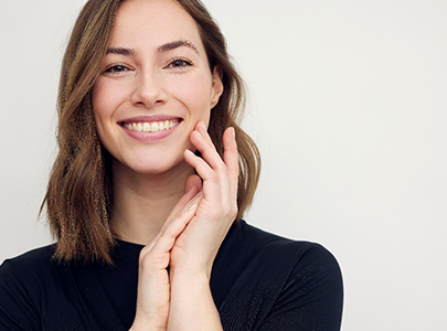 woman smiling after receiving a root canal in Cary