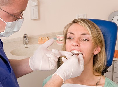 Dentist applying SureSmile aligners in Cary 
