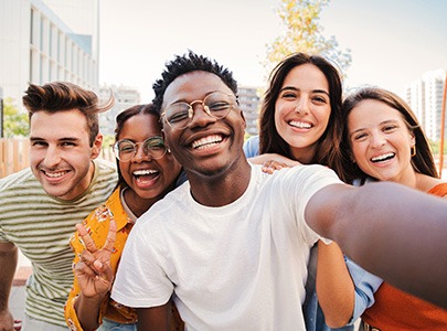 Happy Cary SureSmile patient smiling with friends