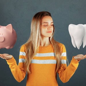 Woman balancing piggy bank and model tooth for the cost of cosmetic dentistry in Cary