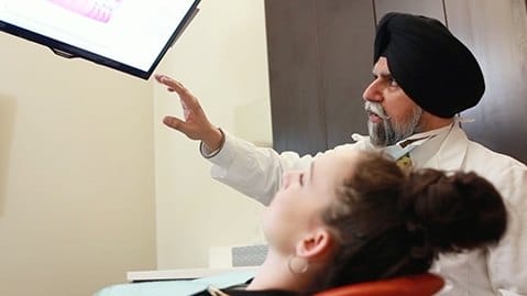 Cary dentist looking at computer screen with patient