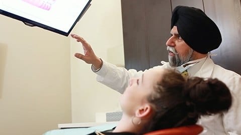 Cary dentist looking at a computer screen with a patient