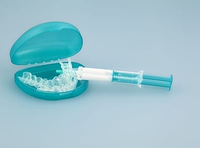 customized teeth whitening trays with a whitening gel syringe