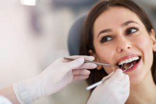 Smiling woman seeing a dentist in Cary