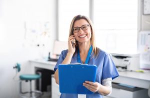 dentist in Cary smiling while talking on the phone 