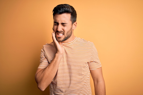 young man experiencing toothache