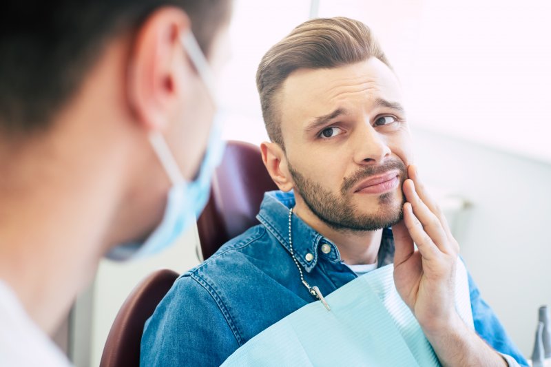 A man suffering from a lost dental filling in Cary