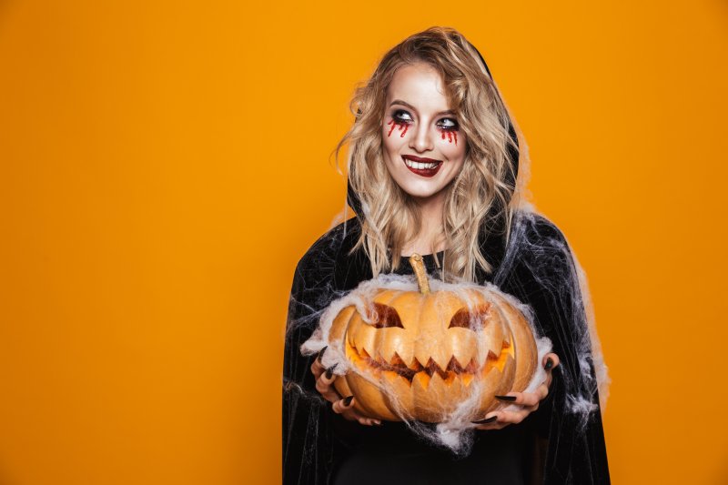 A girl ready for Halloween wearing Invisalign aligners