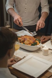 Close up of a man cutting a turkey