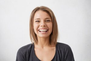 Woman smiling with straight teeth. 