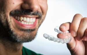 Man putting on his clear aligners